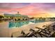 Relaxing community pool with lounge chairs, a clubhouse, and lush landscaping at sunset at 209 Forsythia Ave, Summerville, SC 29483