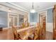 Formal dining room featuring a hardwood floor, large wood table, and french doors at 209 Forsythia Ave, Summerville, SC 29483