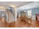 Bright dining room featuring hardwood floors, a staircase, and traditional furnishings at 209 Forsythia Ave, Summerville, SC 29483
