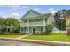 Charming two-story home featuring double porches, complemented by lush greenery and a well-kept lawn at 209 Forsythia Ave, Summerville, SC 29483