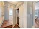 Hallway with laundry closet, wood floors, gray walls with white trim, and view of an adjacent bathroom at 209 Forsythia Ave, Summerville, SC 29483