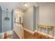 Upstairs hallway with a decorative table and hardwood floors leading to the bedrooms at 209 Forsythia Ave, Summerville, SC 29483