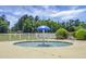 Small outdoor kiddie pool with a blue umbrella in the center, surrounded by a white fence at 209 Forsythia Ave, Summerville, SC 29483