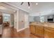 Open-concept kitchen with granite countertops, wooden cabinetry, and hardwood floors flowing into the dining and living areas at 209 Forsythia Ave, Summerville, SC 29483