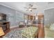Open-concept living area with hardwood floors, a ceiling fan, and a view of the kitchen at 209 Forsythia Ave, Summerville, SC 29483