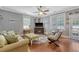 Cozy living room with hardwood floors, a ceiling fan, and plenty of natural light at 209 Forsythia Ave, Summerville, SC 29483