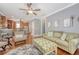 Relaxing living room with hardwood floors, a comfortable couch, and a view of the kitchen at 209 Forsythia Ave, Summerville, SC 29483