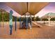 Community playground with a covered play area, slides, and a picnic shelter nearby at dusk at 209 Forsythia Ave, Summerville, SC 29483