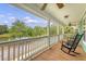 Charming front porch with rocking chairs and views of the pond and landscaped yard at 209 Forsythia Ave, Summerville, SC 29483