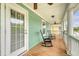 Inviting front porch with ceiling fans and comfortable rocking chairs at 209 Forsythia Ave, Summerville, SC 29483