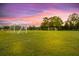 Community soccer field with goals and lush green grass under a colorful sunset sky at 209 Forsythia Ave, Summerville, SC 29483