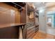 Walk-in closet with custom shelving, drawers, rods and doorway to tiled bedroom at 209 Forsythia Ave, Summerville, SC 29483