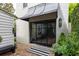 Stylish black framed glass back door with brick landing and modern awning at 21 1/2 Pitt St, Charleston, SC 29401