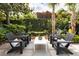 Charming backyard lounge area features a fountain, lush landscaping, and comfortable seating for outdoor relaxation at 21 1/2 Pitt St, Charleston, SC 29401