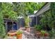 Cozy backyard nook with a storage shed, potting area, and lush greenery at 21 1/2 Pitt St, Charleston, SC 29401