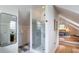 Bright bathroom has glass enclosed shower with marble tiling steps leading to bedroom at 21 1/2 Pitt St, Charleston, SC 29401