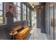 Well-lit bathroom with large windows, designer bench, and access to a private toilet room at 21 1/2 Pitt St, Charleston, SC 29401