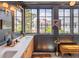 Stylish bathroom featuring double sinks, marble countertops, and expansive windows offering ample natural light at 21 1/2 Pitt St, Charleston, SC 29401