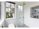 Modern walk-in shower with glass enclosure, window view, and convenient built-in niche at 21 1/2 Pitt St, Charleston, SC 29401