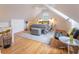 Bright bedroom with hardwood floors, ceiling fan, queen bed, accent chairs, and natural light from a window at 21 1/2 Pitt St, Charleston, SC 29401
