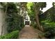 Picturesque courtyard featuring a brick path, lush greenery, and elegant architectural elements at 21 1/2 Pitt St, Charleston, SC 29401