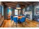 Dining room with brick wall, fireplace, hardwood floors, and exposed beam ceiling at 21 1/2 Pitt St, Charleston, SC 29401