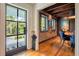 Elegant entryway featuring a glass door, brick walls, hardwood floors, and stylish decor at 21 1/2 Pitt St, Charleston, SC 29401