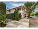 Charming two-story brick home with iron gate, manicured landscaping, and welcoming curb appeal at 21 1/2 Pitt St, Charleston, SC 29401