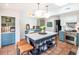 Spacious kitchen featuring an island, terracotta floors, stainless steel appliances, and custom cabinets at 21 1/2 Pitt St, Charleston, SC 29401