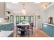 Bright kitchen featuring terracotta floors, custom cabinets, skylights, and a marble island at 21 1/2 Pitt St, Charleston, SC 29401
