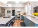 Bright kitchen featuring terracotta floors, custom cabinets, stainless steel appliances, and a center island at 21 1/2 Pitt St, Charleston, SC 29401