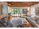 Inviting living room featuring a fireplace, exposed beams, a large sectional, and hardwood floors at 21 1/2 Pitt St, Charleston, SC 29401