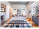 Well-lit bedroom with a fireplace, bench, hardwood floors, and crown molding at 21 1/2 Pitt St, Charleston, SC 29401