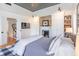 Spacious main bedroom with a fireplace, built-in shelves, natural light, and hardwood floors at 21 1/2 Pitt St, Charleston, SC 29401