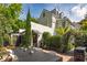 Elegant patio with an outdoor dining set, manicured greenery, and charming exterior lighting creating a warm ambiance at 21 1/2 Pitt St, Charleston, SC 29401