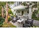 Beautiful outdoor patio with stylish furniture, a relaxing lounge chair, and a covered seating area for entertaining at 21 1/2 Pitt St, Charleston, SC 29401