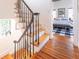 Staircase with wooden steps, a wrought iron railing, and views into the Primary bedroom at 21 1/2 Pitt St, Charleston, SC 29401