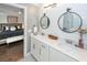 Bright bathroom featuring dual vanity, marble countertops, shiplap accent wall, and views into main bedroom at 2119 Oyster Reef Lane Ln, Mount Pleasant, SC 29466