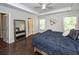 Spacious bedroom with dark hardwood floors, a modern ceiling fan, and a full-length mirror at 2119 Oyster Reef Lane Ln, Mount Pleasant, SC 29466