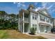 Bright townhome with a covered porch, green lawn, and an attached garage on a sunny day at 2119 Oyster Reef Lane Ln, Mount Pleasant, SC 29466