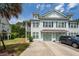 Charming two-story townhome with a covered porch, well maintained lawn, and an attached garage at 2119 Oyster Reef Lane Ln, Mount Pleasant, SC 29466
