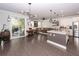 Open-concept living space with kitchen island, stainless steel appliances, and sliding glass door to patio at 2119 Oyster Reef Lane Ln, Mount Pleasant, SC 29466
