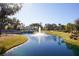 Scenic view of a community pond featuring a fountain with lush green landscaping and attractive houses in the background at 2119 Oyster Reef Lane Ln, Mount Pleasant, SC 29466
