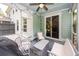 Cozy screened-in porch offering a relaxing outdoor space with comfortable seating and ceiling fan at 2119 Oyster Reef Lane Ln, Mount Pleasant, SC 29466