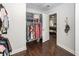 Walk-in closet leads to bedroom and features wood floor, custom shelving, and hanging racks for optimal organization at 2119 Oyster Reef Lane Ln, Mount Pleasant, SC 29466