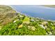 This aerial view shows the marshy coastline with homes and boat docks along the water and trees in the foreground at 2169 Westrivers Rd, Charleston, SC 29412