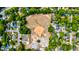 An aerial view shows a baseball field surrounded by trees and multiple houses on a clear day, with a field in the foreground at 2169 Westrivers Rd, Charleston, SC 29412