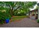 Screened-in porch overlooking backyard with large oak trees at 2169 Westrivers Rd, Charleston, SC 29412