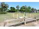The neighborhood baseball field features a wood fence in the foreground and mature trees surrounding the play area in the background at 2169 Westrivers Rd, Charleston, SC 29412