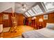 Cozy bedroom featuring wood paneling, skylights, hardwood floors and a ceiling fan at 2169 Westrivers Rd, Charleston, SC 29412
